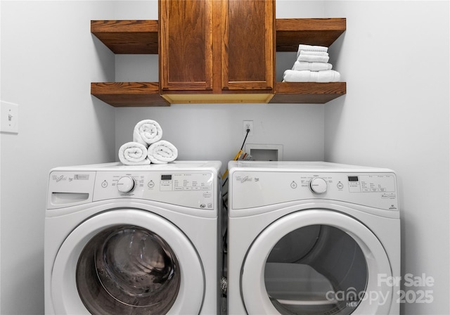 laundry area with cabinet space and separate washer and dryer