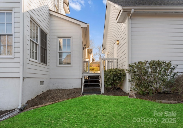 view of home's exterior with a yard, crawl space, and roof with shingles