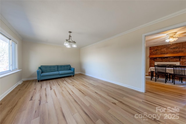 unfurnished room featuring an inviting chandelier, crown molding, and light wood-type flooring