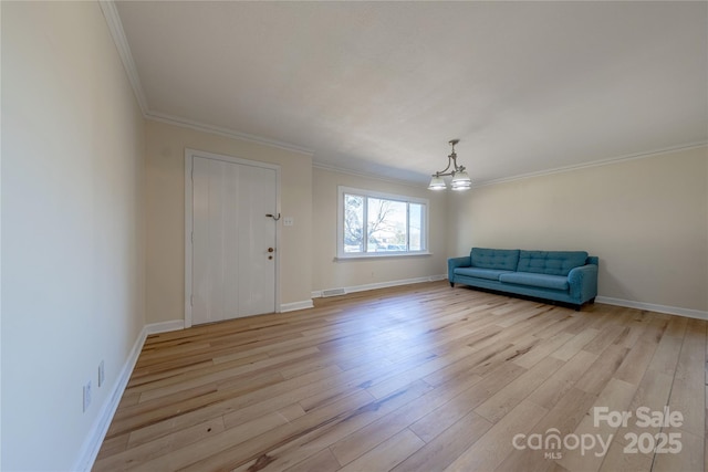 interior space with ornamental molding, light hardwood / wood-style flooring, and a notable chandelier