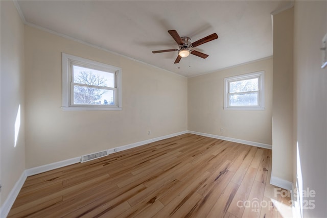 spare room with light hardwood / wood-style flooring, ornamental molding, and ceiling fan