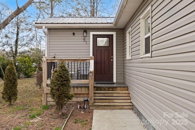 property entrance featuring metal roof