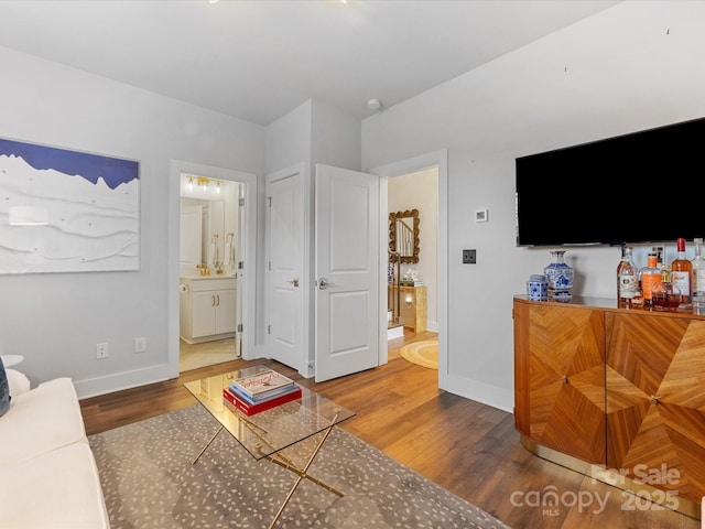 living room featuring hardwood / wood-style flooring and bar area