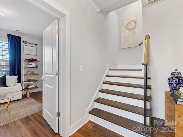 staircase with hardwood / wood-style floors