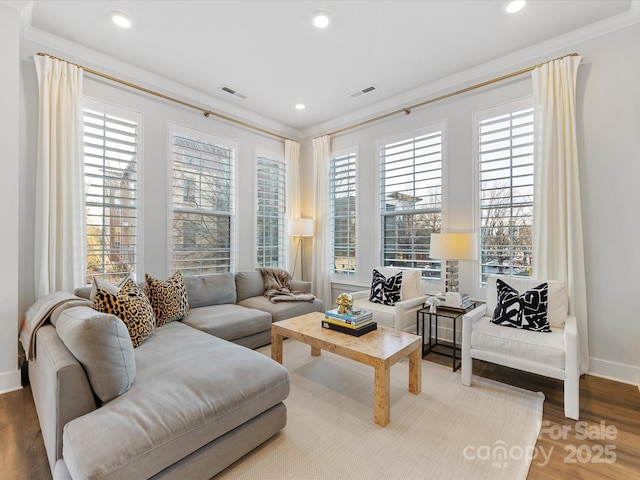 living room featuring crown molding and hardwood / wood-style flooring