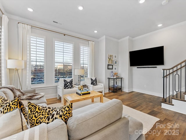 living room featuring hardwood / wood-style flooring and ornamental molding