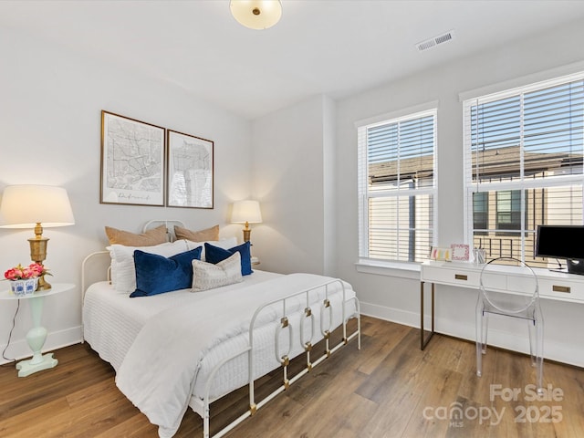 bedroom with hardwood / wood-style flooring