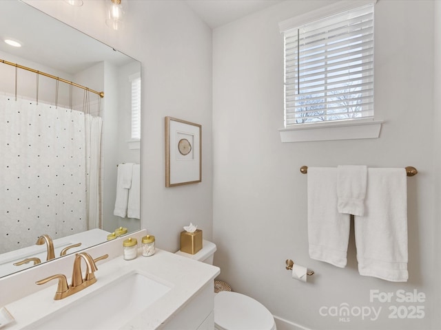 bathroom with vanity, toilet, and a shower with shower curtain