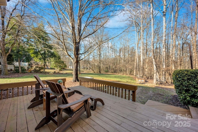 wooden terrace featuring a lawn