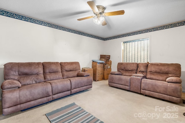 carpeted living area featuring a ceiling fan