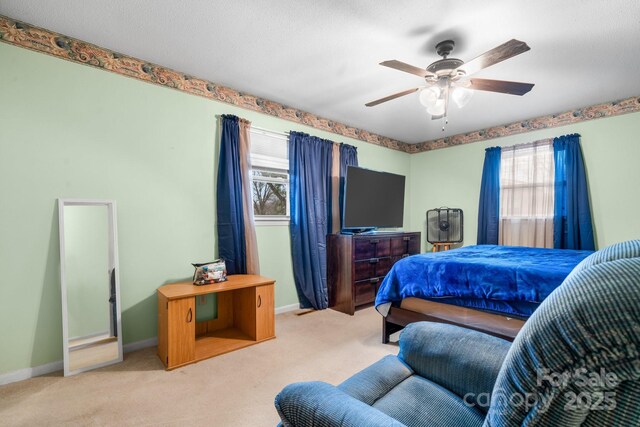 bedroom featuring baseboards, carpet, and a ceiling fan