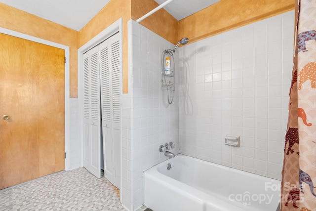 bathroom featuring tile patterned floors, a closet, and shower / bath combination with curtain