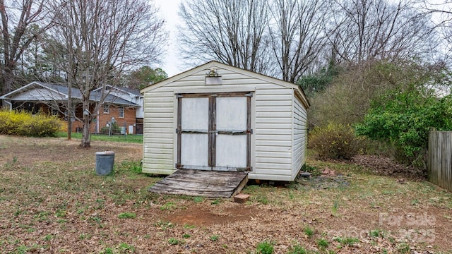 view of shed with fence