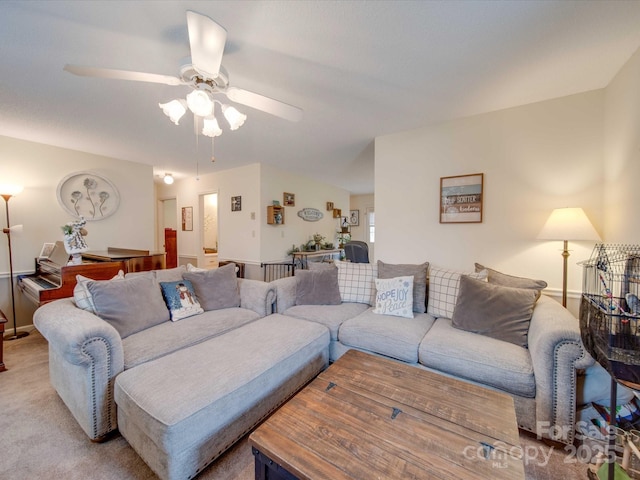 living room featuring light colored carpet and ceiling fan