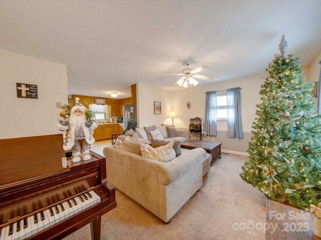 carpeted living room with ceiling fan