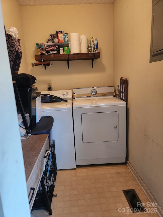 clothes washing area with electric panel and washer and clothes dryer