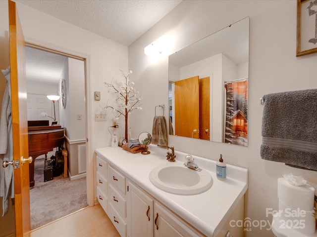 bathroom featuring vanity and a textured ceiling