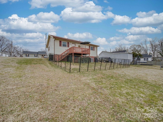 back of house featuring a yard and a deck