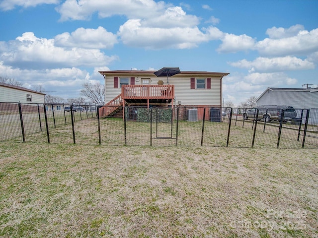 rear view of property with a deck and a lawn