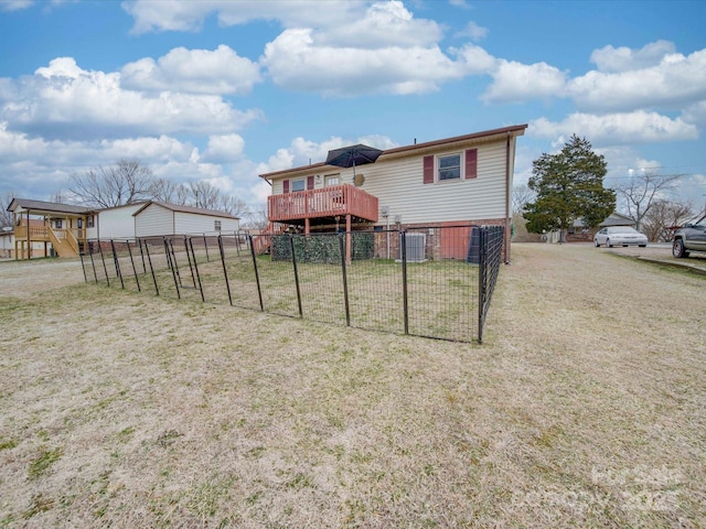 rear view of house with a yard, a deck, and central air condition unit