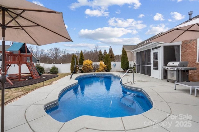 view of pool featuring a playground, a sunroom, grilling area, and a patio area