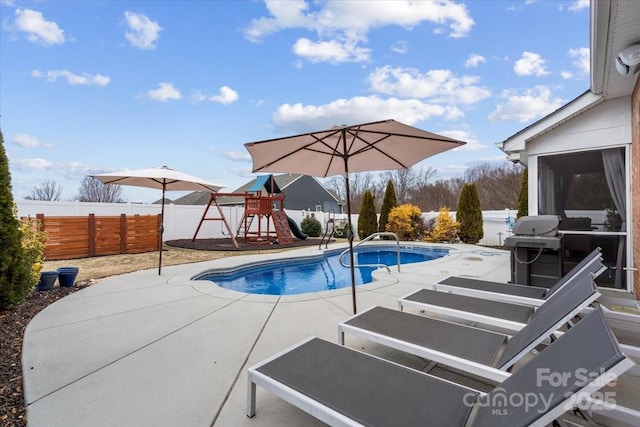 view of pool featuring a playground and a patio area