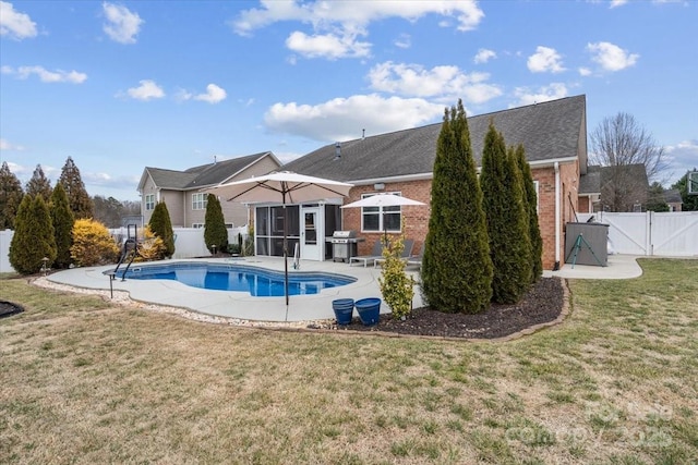 view of swimming pool with area for grilling, a yard, and a patio