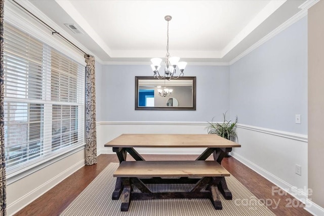 dining area featuring a tray ceiling, a notable chandelier, dark hardwood / wood-style floors, and breakfast area