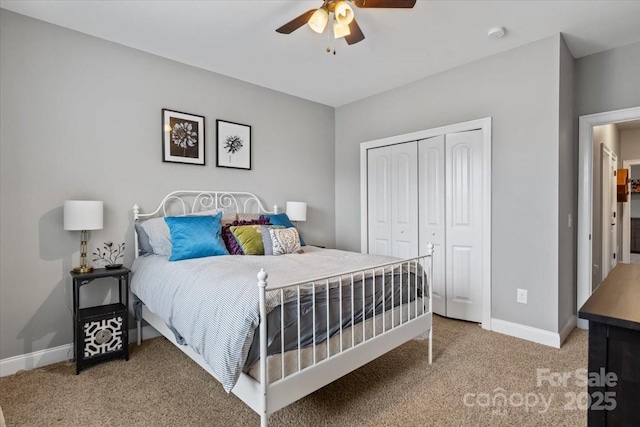 carpeted bedroom featuring a closet and ceiling fan