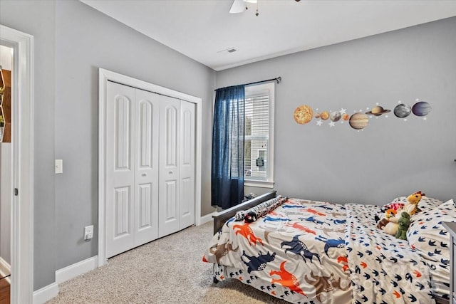 carpeted bedroom with a closet and ceiling fan