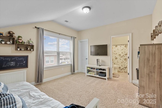 carpeted bedroom with lofted ceiling and connected bathroom