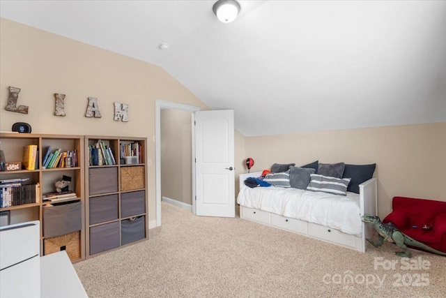 carpeted bedroom featuring lofted ceiling