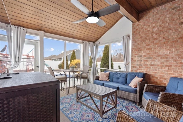 sunroom / solarium featuring wood ceiling, lofted ceiling with beams, and ceiling fan