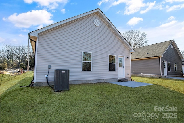 back of house featuring a yard, a patio, and central air condition unit