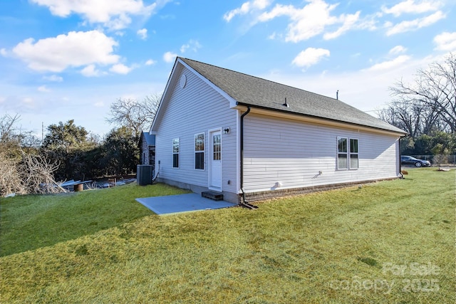 view of property exterior featuring a patio, a yard, and central AC unit