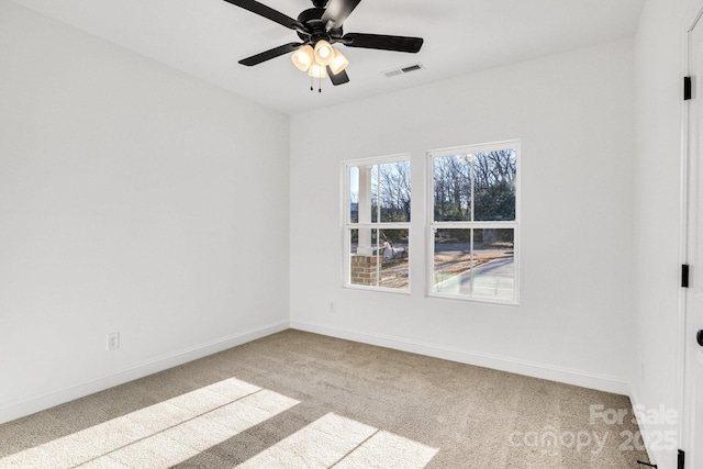 spare room featuring light carpet and ceiling fan