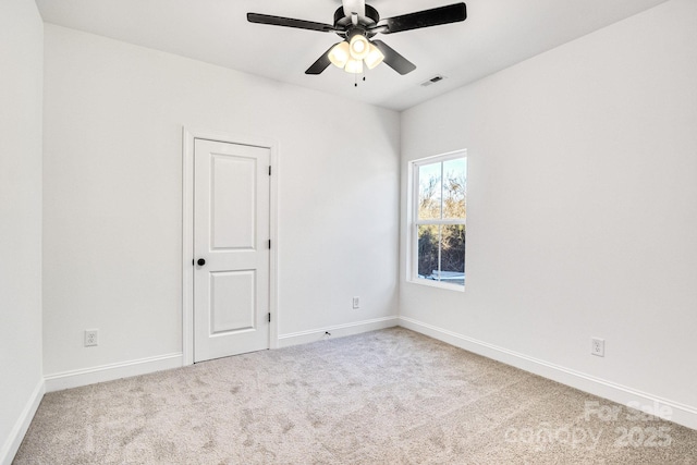 spare room with light colored carpet and ceiling fan