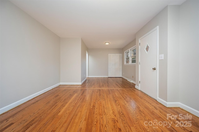 unfurnished room with light wood-type flooring