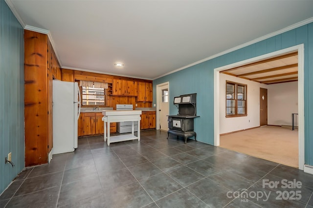 kitchen with white refrigerator, ornamental molding, sink, and stove