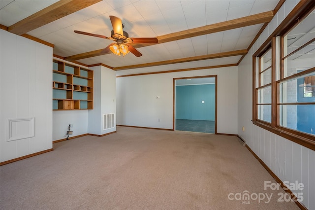 unfurnished room featuring beam ceiling, light colored carpet, and ceiling fan