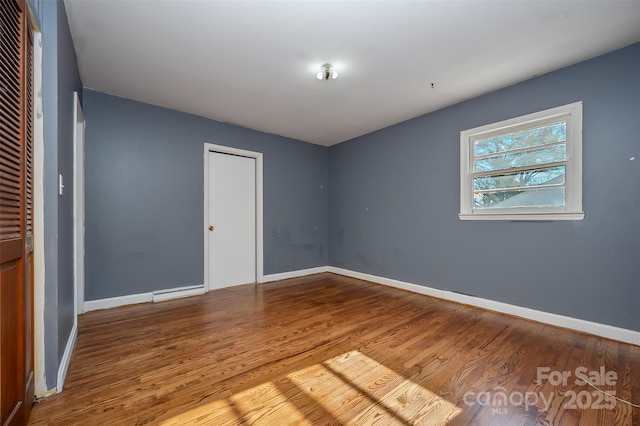 unfurnished bedroom with hardwood / wood-style floors and a closet