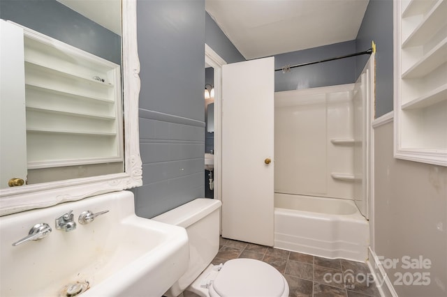 full bathroom with toilet, sink, shower / bathing tub combination, and tile walls