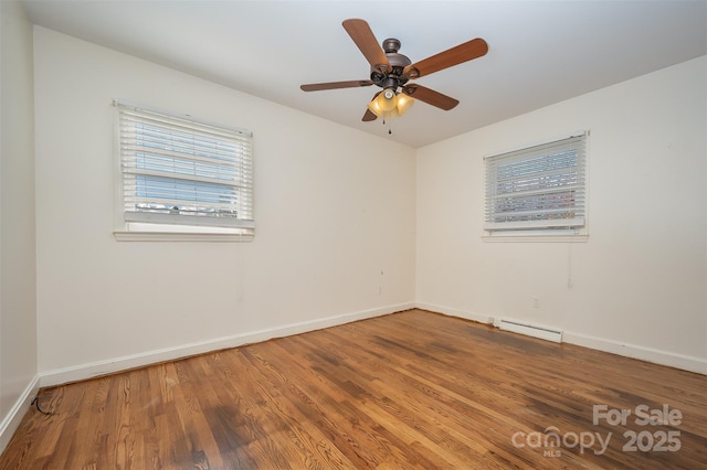 unfurnished room with hardwood / wood-style floors, ceiling fan, and a baseboard heating unit