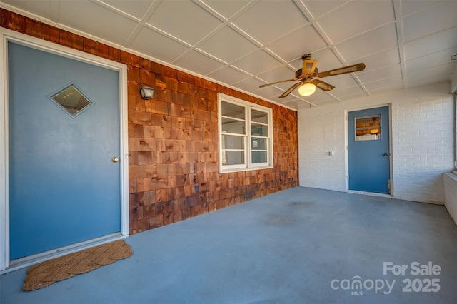 doorway to property with ceiling fan and a patio area