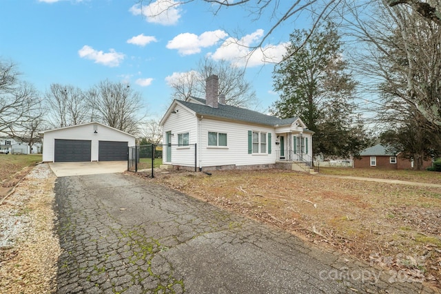 view of front of home featuring an outbuilding and a garage