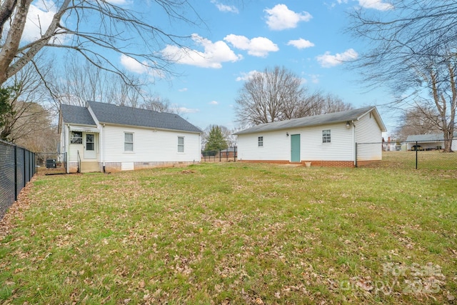 rear view of property with a yard