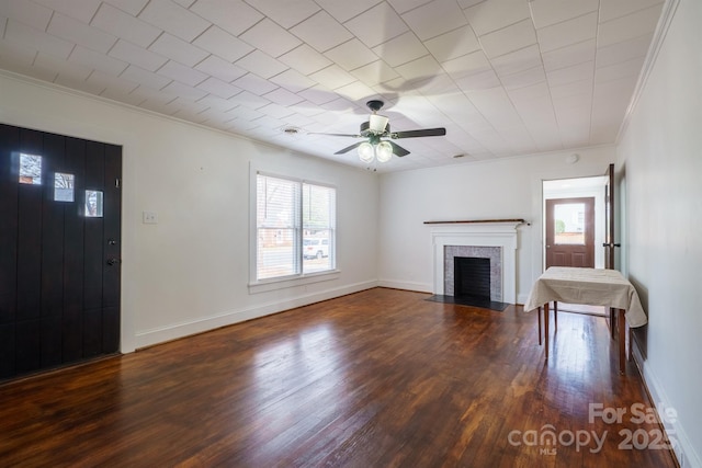 unfurnished living room featuring ornamental molding, plenty of natural light, dark hardwood / wood-style flooring, and a brick fireplace