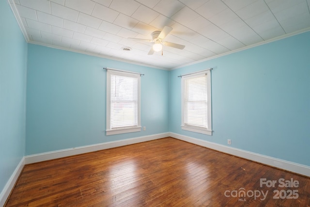 empty room with ornamental molding, hardwood / wood-style floors, and ceiling fan