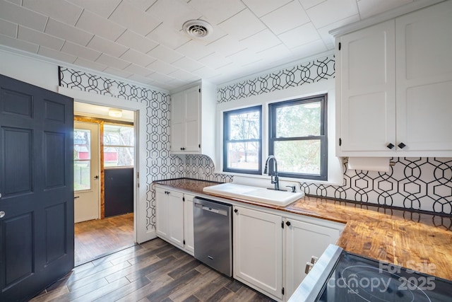 kitchen with white cabinetry, sink, wood counters, and dishwasher