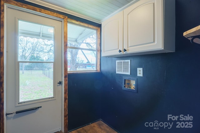 laundry room with washer hookup, crown molding, dark wood-type flooring, and cabinets